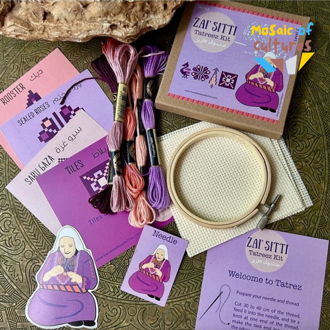 Embroidery kit with threads, hoop, and instructions on a textured surface