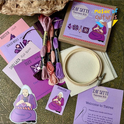 Embroidery kit with threads, hoop, and instructions on a textured surface