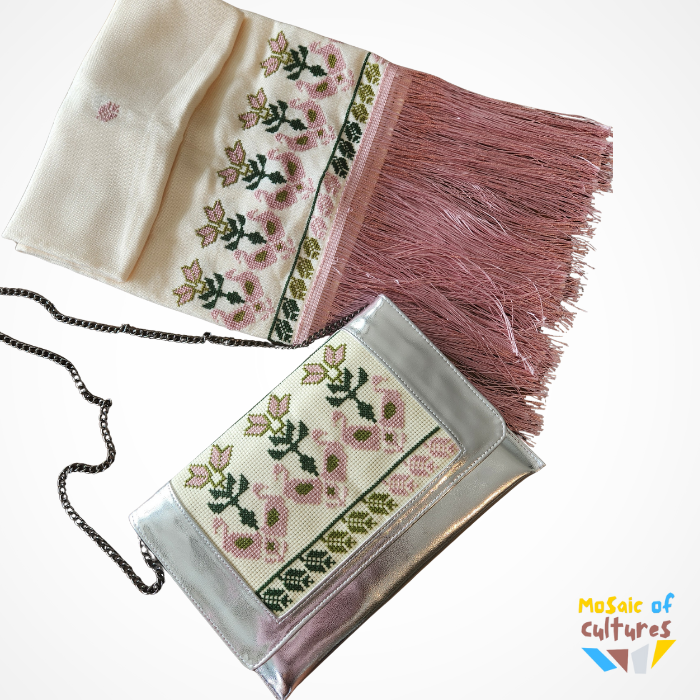 Embroidered clutch bag with floral patterns and tassels on a white background, featuring the brand 'Mosaic of Cultures'.